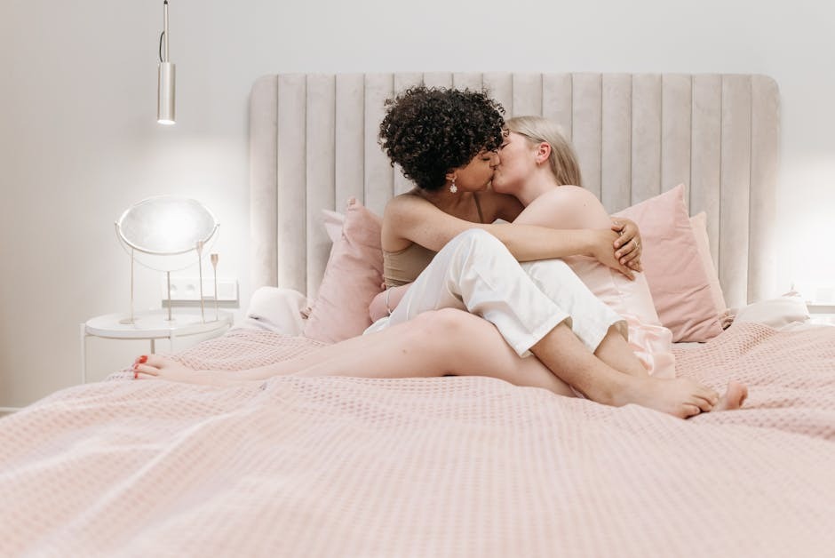 Two women sharing an intimate moment on a bed, representing the authentic connections that follow careful verification